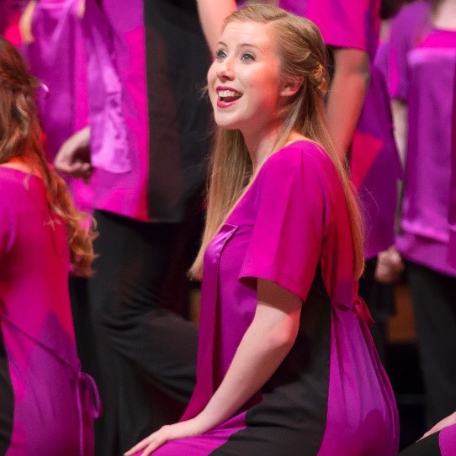 AGC member Grace performs in a group number on stage during a concert