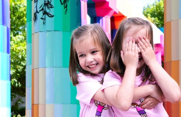 Two girls play hide and seek together