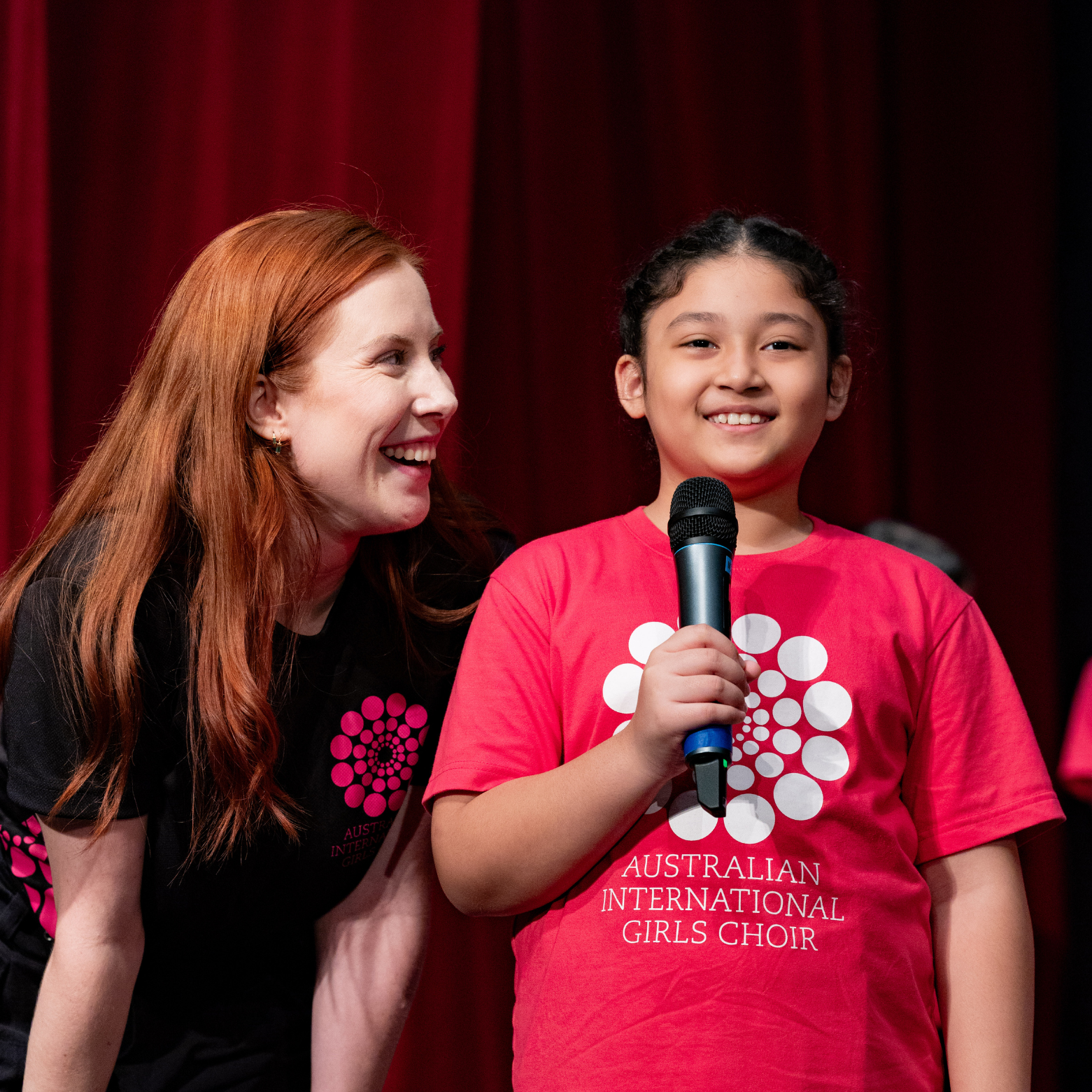 IGC Instructor Grace encourages a chorister on stage